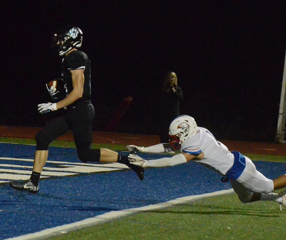 Wallkill’s Jack Rauschenbach runs into the end zone for a touchdown as Goshen’s Ariel LaSalle makes a last attempt at a tackle during Friday’s Class A football game.